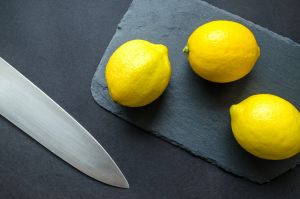 photo of three lemons on chopping board near knife 952369
